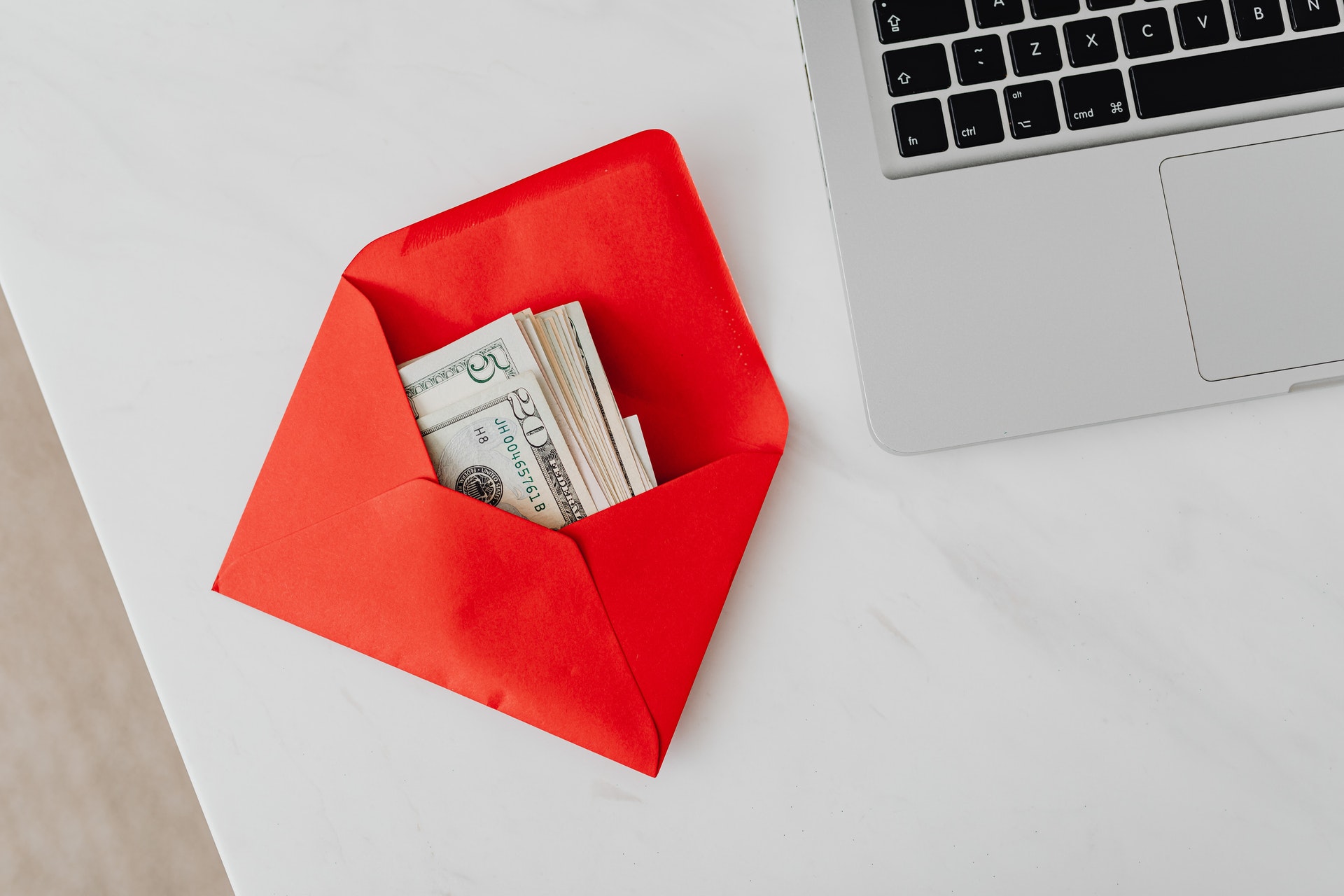 red envelope with money on desk